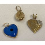 3 gold charms/pendants in varying styles.