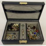 A black faux leather jewellery box containing a collection of vintage and modern costume jewellery.