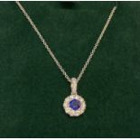 An 18ct white gold sapphire and diamond pendant on a 20 inch fine chain, by Luke Stockley, London.