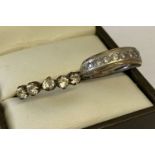 A vintage silver eternity style ring set with 9 small round cut diamonds, ring size M½.