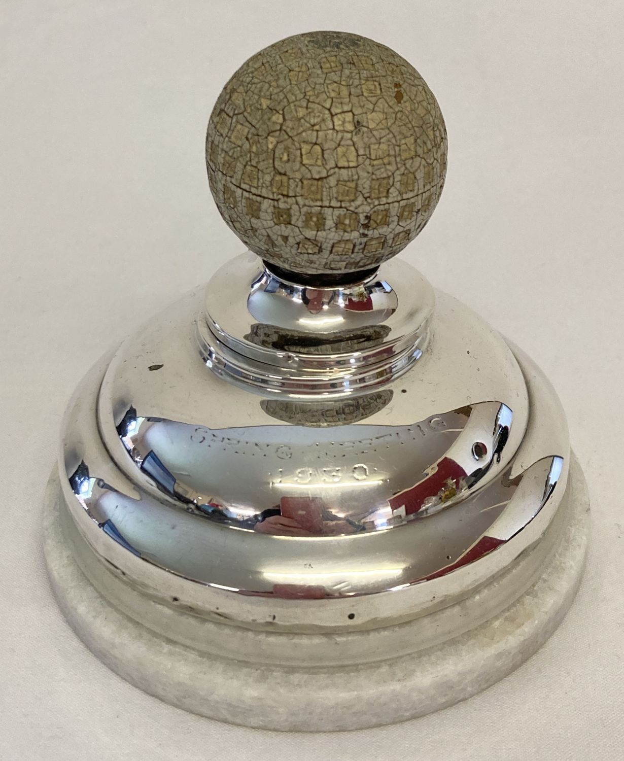 A vintage silver inkwell with golf ball finial and filled base. Lid hinge needs attention.