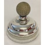 A vintage silver inkwell with golf ball finial and filled base. Lid hinge needs attention.