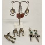 5 pairs of silver and white metal earrings, all in a drop style. To include stone set and frogs.