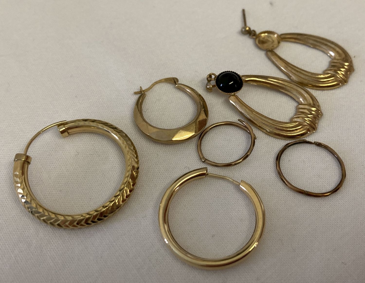 A small quantity of scrap gold single earrings.