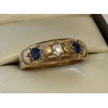 A vintage 18ct gold gypsy style ring set with central .15ct diamond and with a sapphire either side.