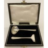 A cased silver Art Deco babies feeding spoon and pusher, fully hallmarked.