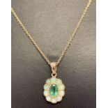 A 9ct gold emerald and opal set pendant on a 20 inch fine chain, by Luke Stockley, London.