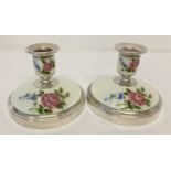 A pair of vintage silver and white guilloche candlesticks with hand painted floral detail.
