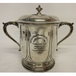 A large antique silver 2 handled, lidded winners cup, hallmarked London 1905.