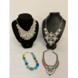 4 modern design costume jewellery statement necklaces in varying designs.