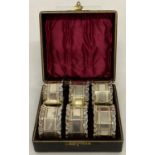 A boxed set of vintage silver plated, decorative napkin rings with engraved borders & frilled rims.