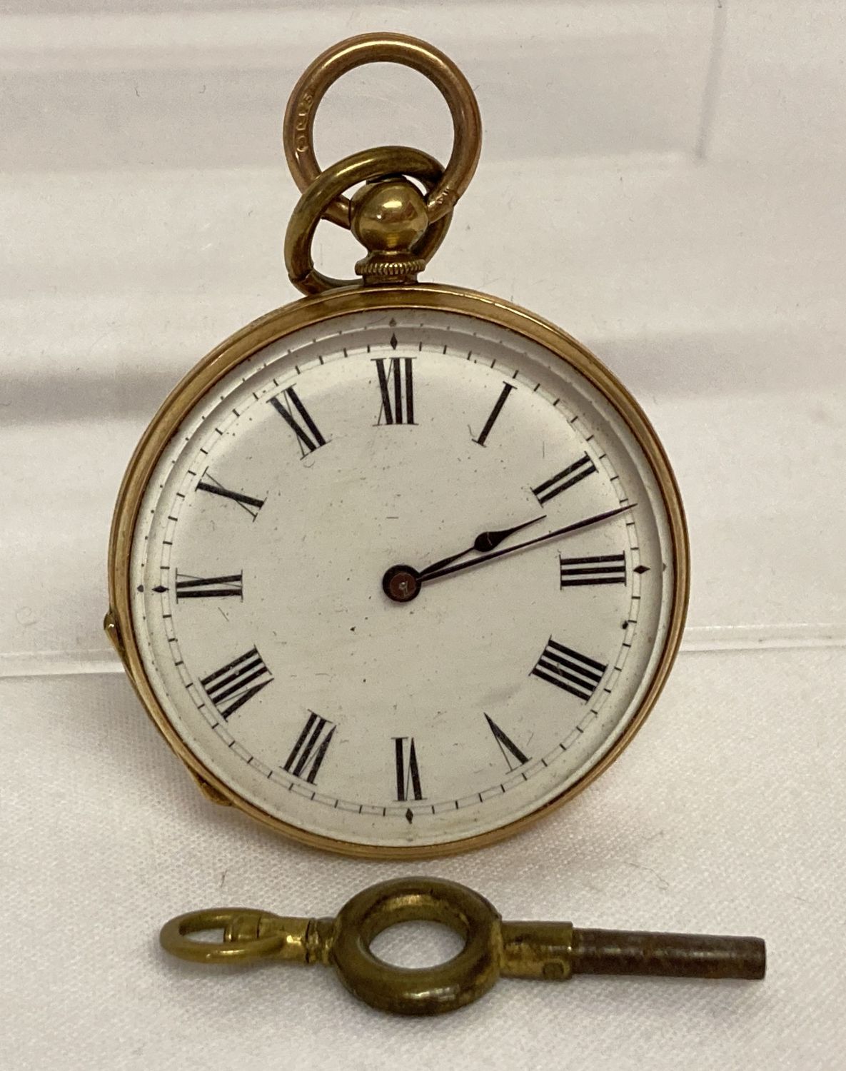 A vintage 14ct gold cased ladies pocket watch with enamelled face and key. In working order.