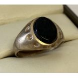 A vintage 9ct gold signet ring set with an oval onyx stone.
