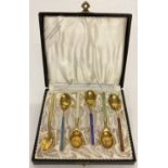 A boxed set of Meka Danish silver gilt demitasse spoons with coloured enamelled handles.