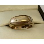 An 18ct gold buckle design band ring, design very worn.