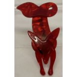 A Lea Stein style lucite pin back brooch in the shape of a fox with a curled tail.