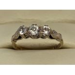A vintage 9ct gold clear diamond set trilogy ring with decorative detail to shoulders.