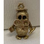 A yellow gold wise owl charm/pendant.