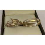2 9ct gold rings, a wedding band together with a double leaf design ring.