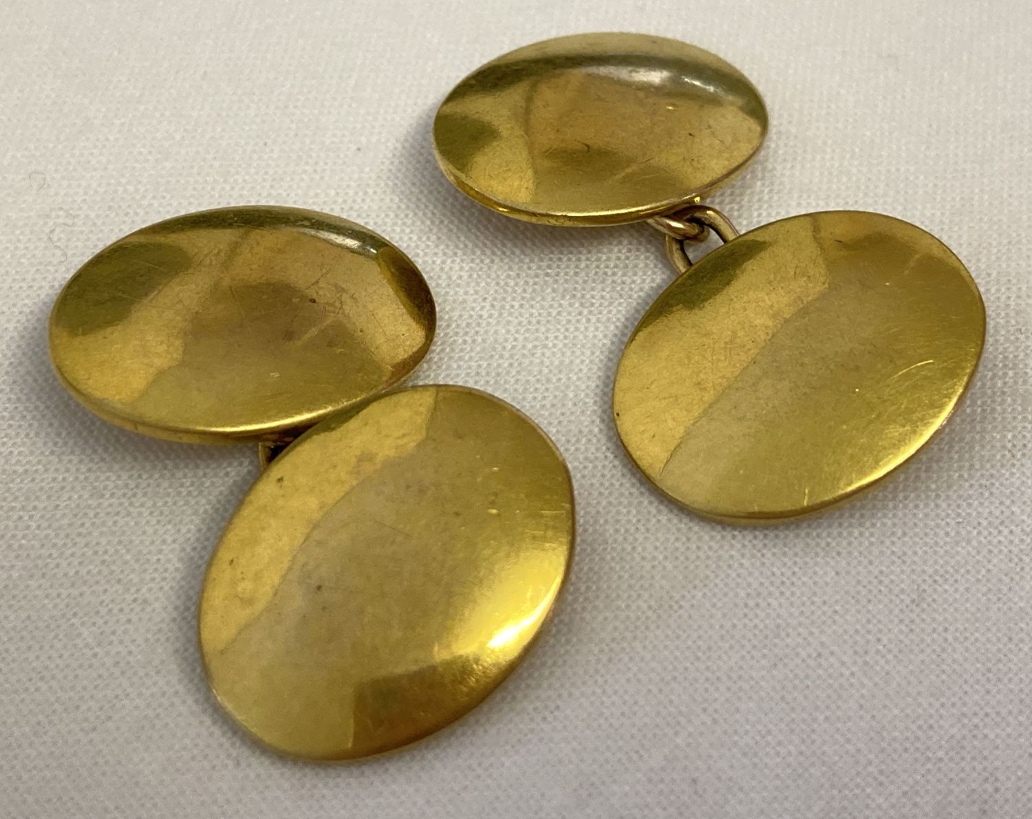 A pair of vintage 9ct gold, plain oval cufflinks. Marked 9ct to backs.