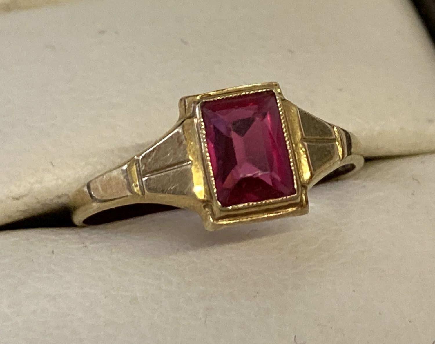 A vintage 18ct gold dress ring set with an emerald cut rubellite stone.