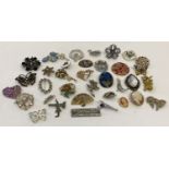 A collection of 35 vintage and modern brooches and scarf clips in varying conditions.