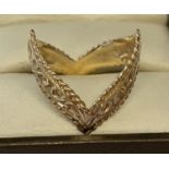 A 9ct gold double wishbone dress ring with scroll decoration throughout.