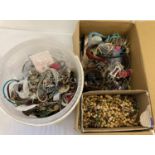 A box and a tub of mixed costume jewellery. To include earrings, chains, necklaces and bracelets.