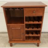 A modern solid wood wine rack unit with single drawer and cupboard.