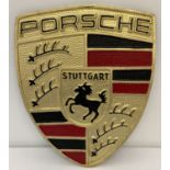 A large painted aluminium, Porsche shield shaped wall plaque, with fixing hooks to reverse.