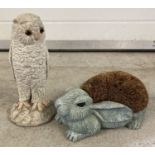 A doorstop boot cleaner in the shape of a rabbit together with a concrete owl garden ornament.