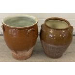 2 large brown glazed terracotta garden pots in an urn style.