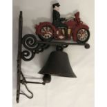A modern painted cast metal wall hanging garden bell with motorcycle and rider detail.