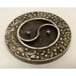 A Chinese white metal ink stone with yin and yang design to centre.