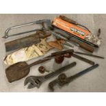 A collection of assorted vintage hand tools to include oil cans, wooden handled saws and files.