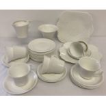 A quantity of Shelley tea ware in plain white glaze, some pieces with green backstamp.