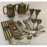A collection of vintage silver plated cutlery, together with decorative grape scissors and goblets.