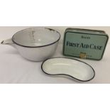 3 items of enamel ware. A mixing bowl with pouring spout and a kidney shaped shallow dish.