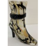 An art glass vase in the shape of a boot in black, brown and cream colourway.
