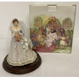 A boxed 'The Leonardo Collection' resin figure of a bride on a wooden plinth.