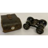 A small pair of French antique cyclist binoculars, marked "La Bicycliste", in a leather case.