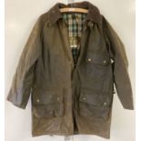 A vintage Barbour wax jacket with detachable hood and exterior pockets.