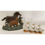 2 decorative painted cast metal doorstops in the shapes of horse and foal and row of ducks.