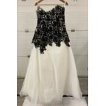 A full length strapless ball gown style wedding dress by Amanda Wyatt, in ivory tulle & black lace.