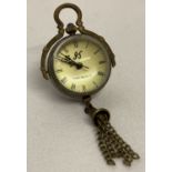A brass bound ball watch pendant with tassel detail, roman numeral markers & hinged pendant bale.
