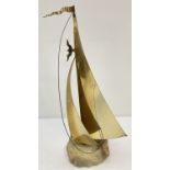 A vintage brass sail boat sculpture on a pale green onyx base by John & Don Demott.