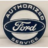 A cast iron, circular shaped Ford Authorized Service wall plaque.