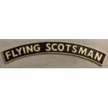 A large curve shaped cast metal Flying Scotsman wall hanging sign with fixing holes.