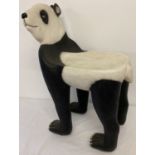 A heavy resin novelty child's seat in the shape of a panda bear.