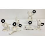 A collection of 6 small painted cast metal Michelin men figures, carrying tyres.